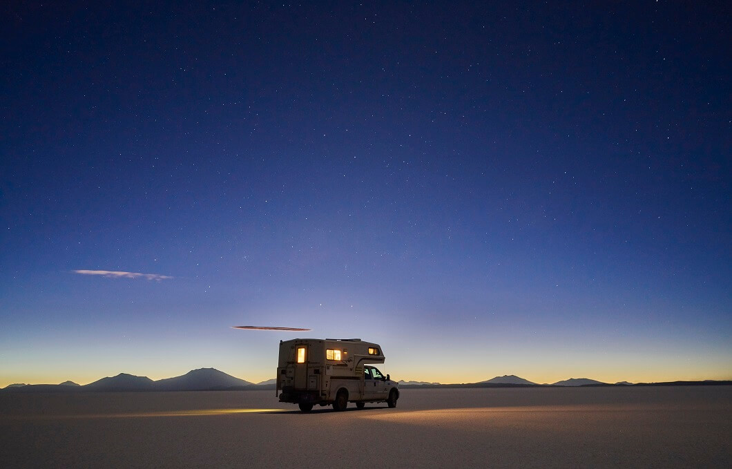 recreational-vehicle-travelling-at-dusk-across-s-2022-03-07-23-52-20-utc